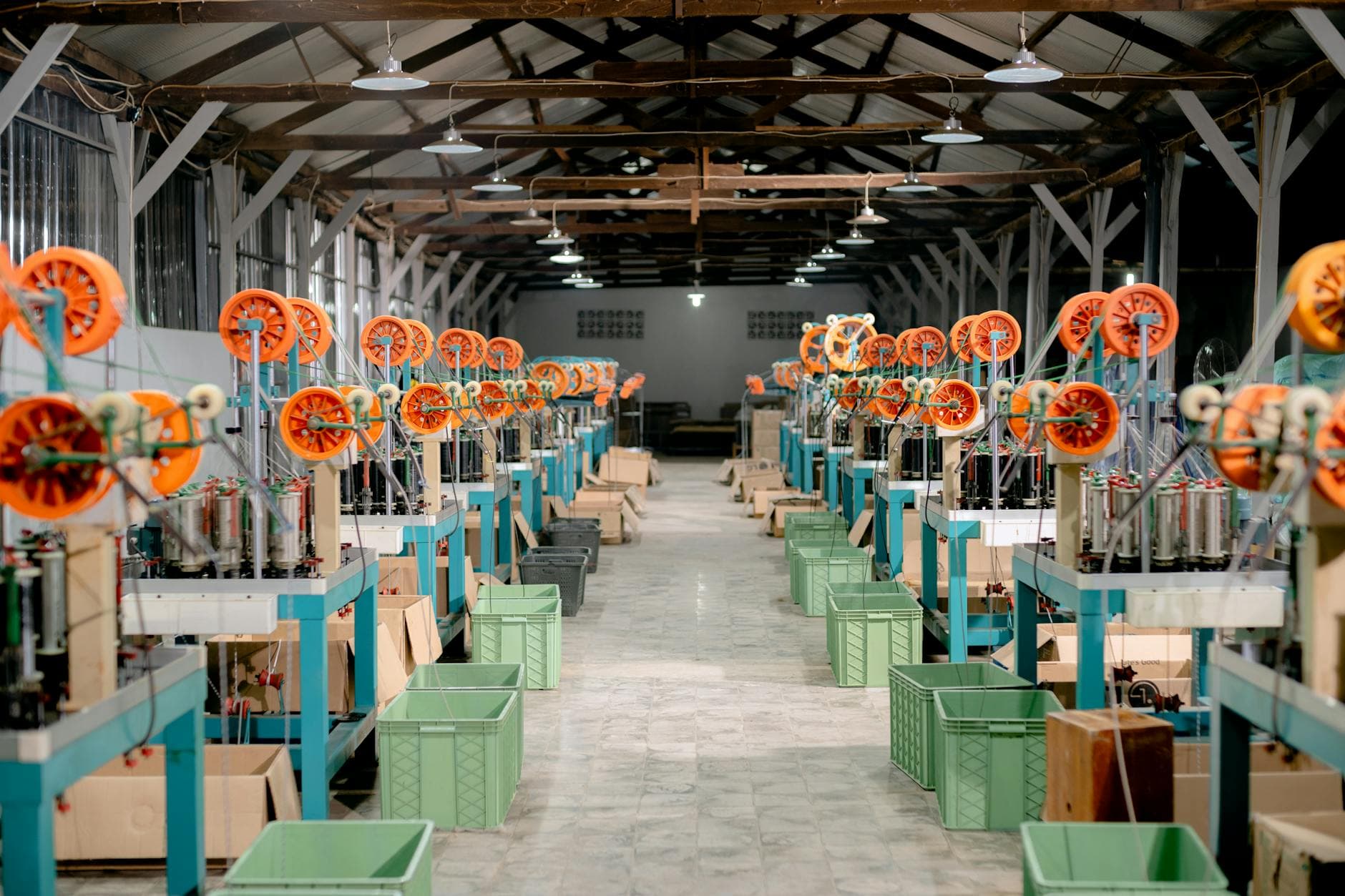 Clean industrial production hall with stainless equipment and overhead lighting.