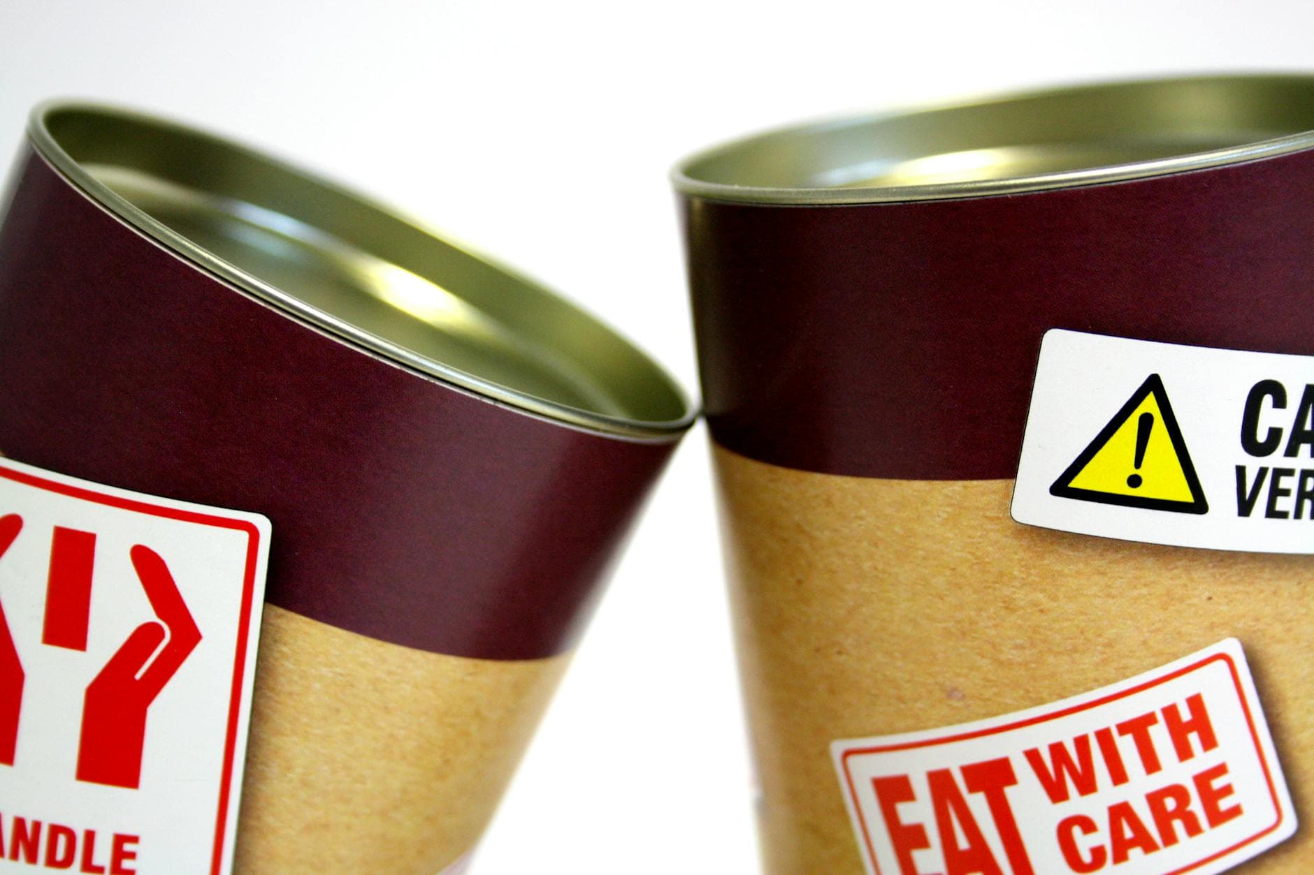 Warning labels on canned food containers showing mandatory information requirements under EU FIC Regulation 1169/2011