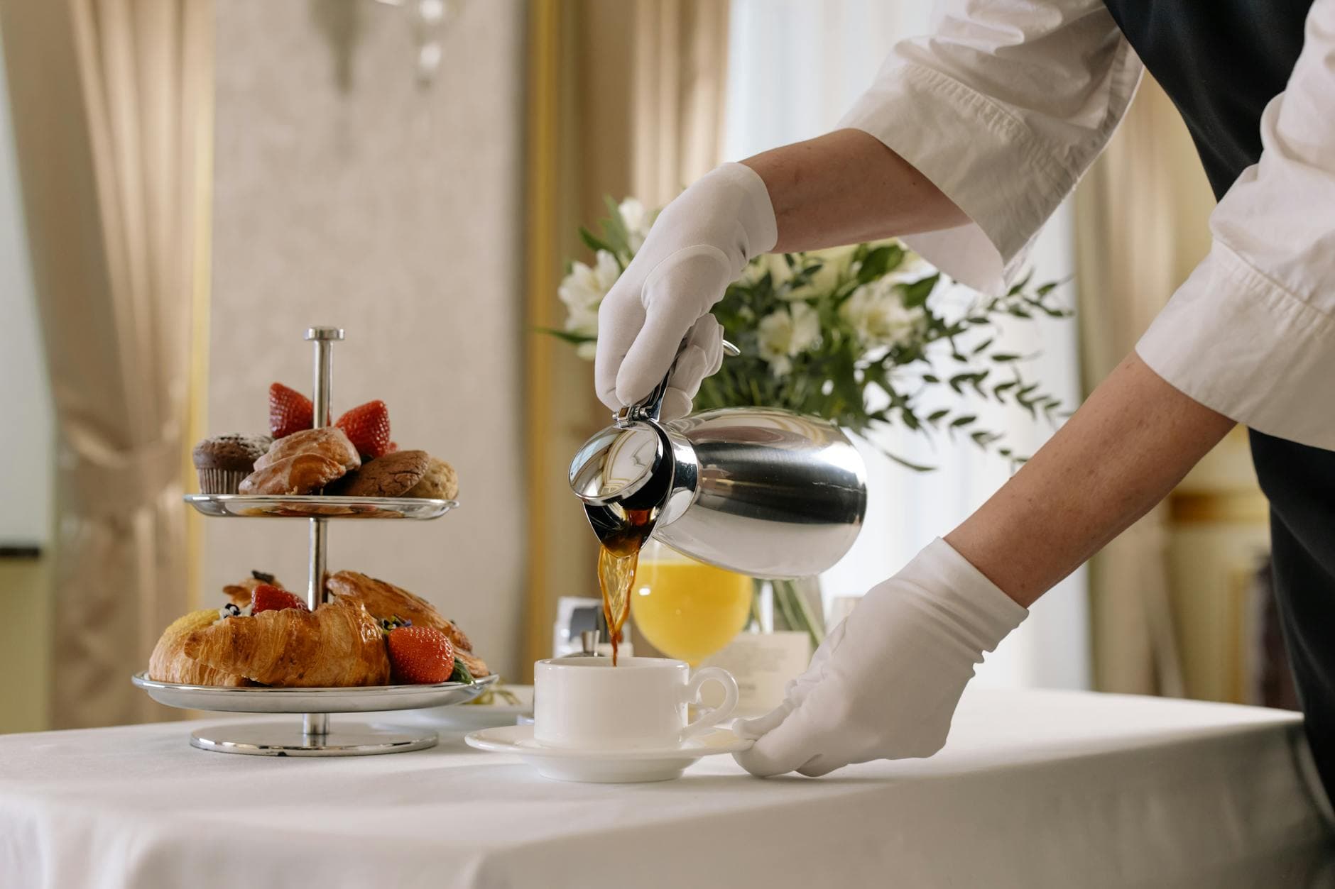 Elegant morning setup with coffee and pastries showcasing luxury room service