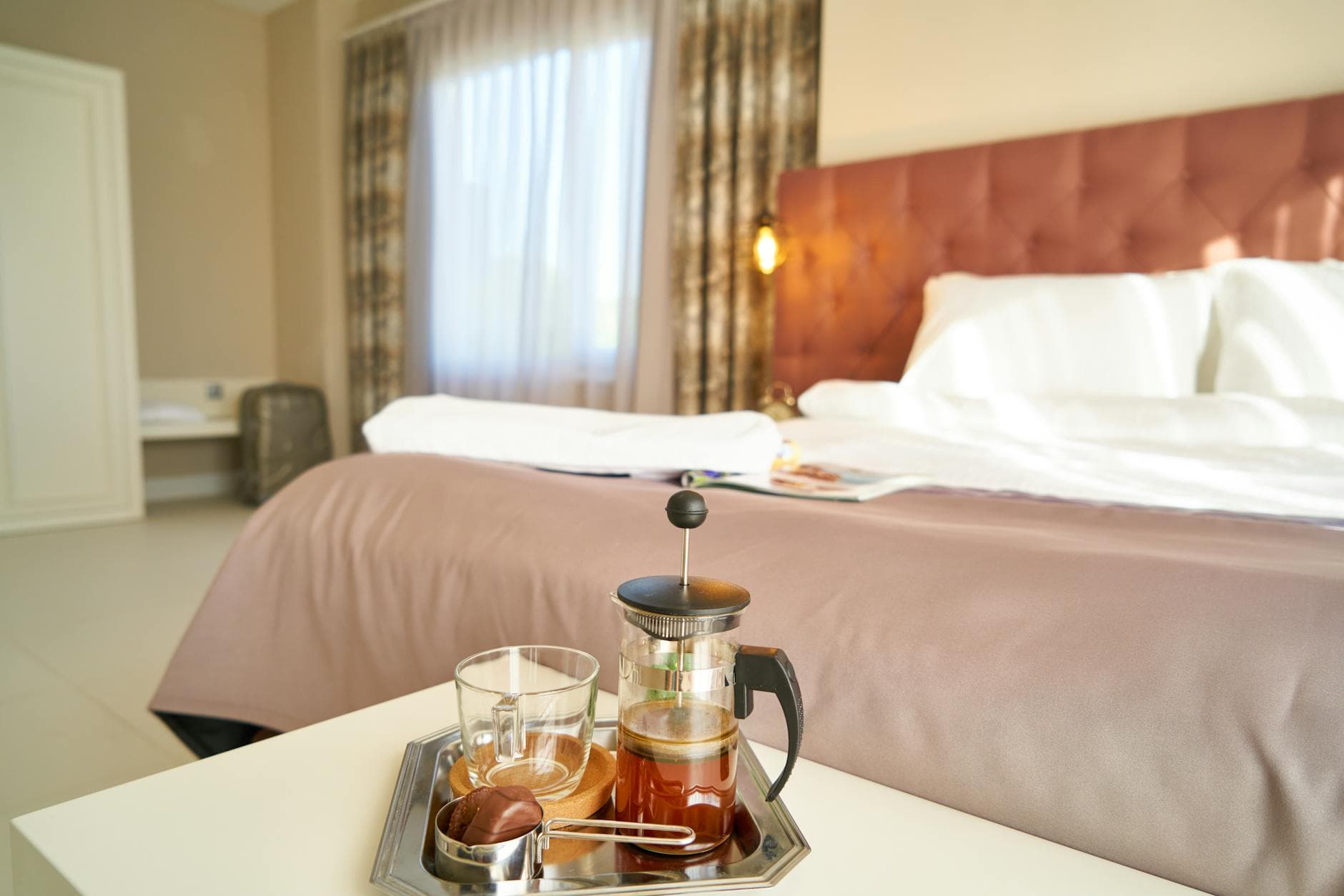 Hotel room with coffee setup on the bedside table