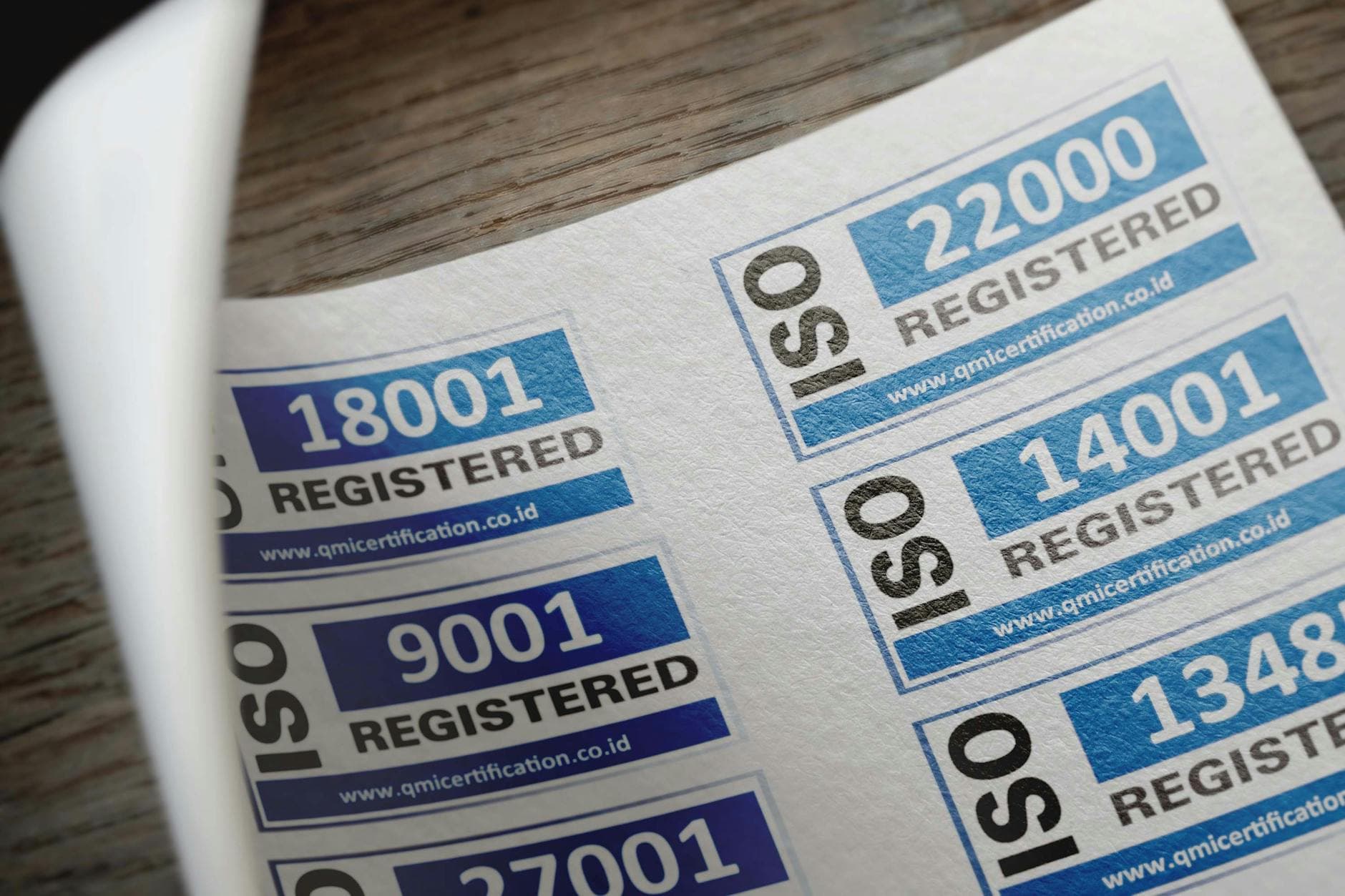 ISO certification stickers with registration numbers printed on paper, food safety quality standards