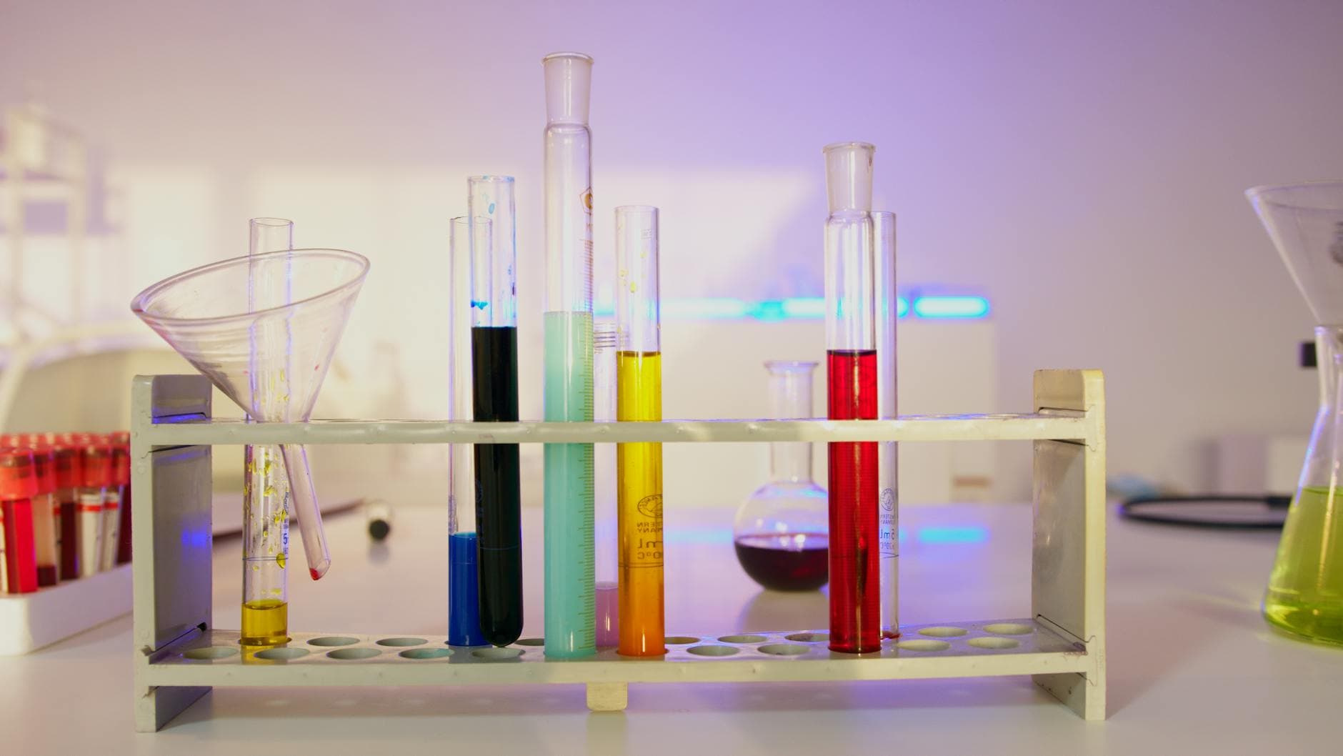 Vibrant test tubes filled with liquid samples in a modern laboratory setting for mineral oil hydrocarbon analysis