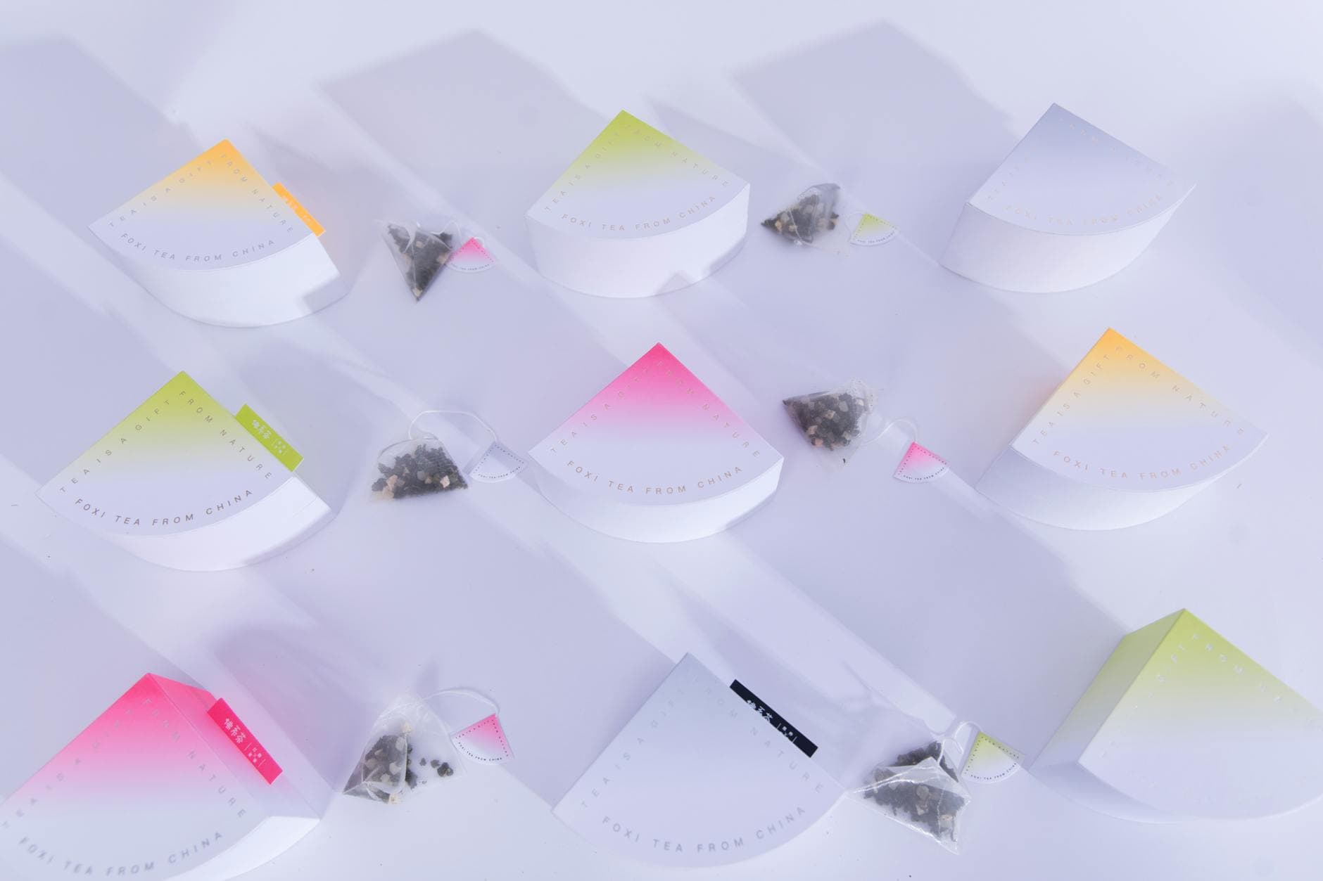 Flat lay of colorful tea packaging showing various envelope materials and formats used for B2B private-label tea production