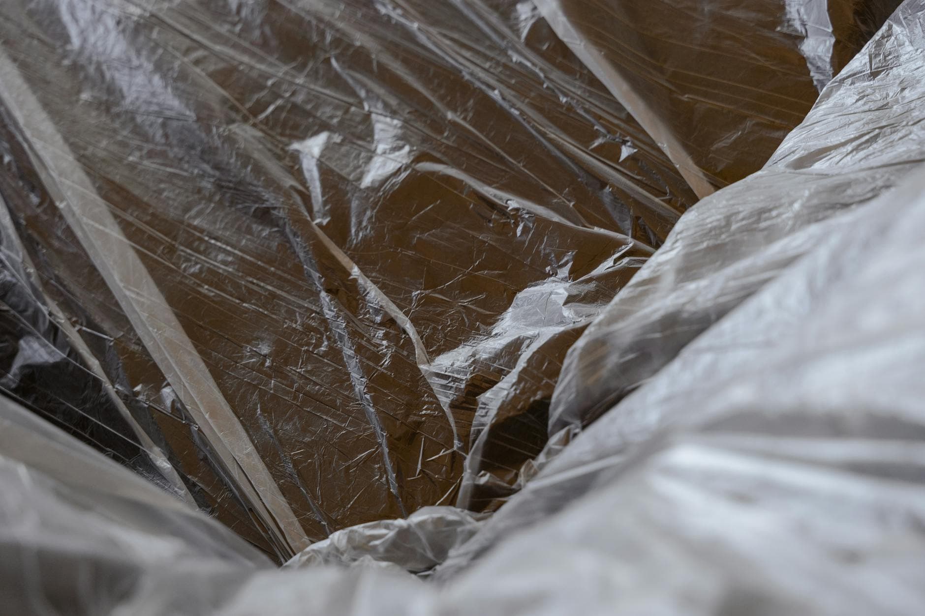 Close-up of transparent plastic packaging material over wooden surface