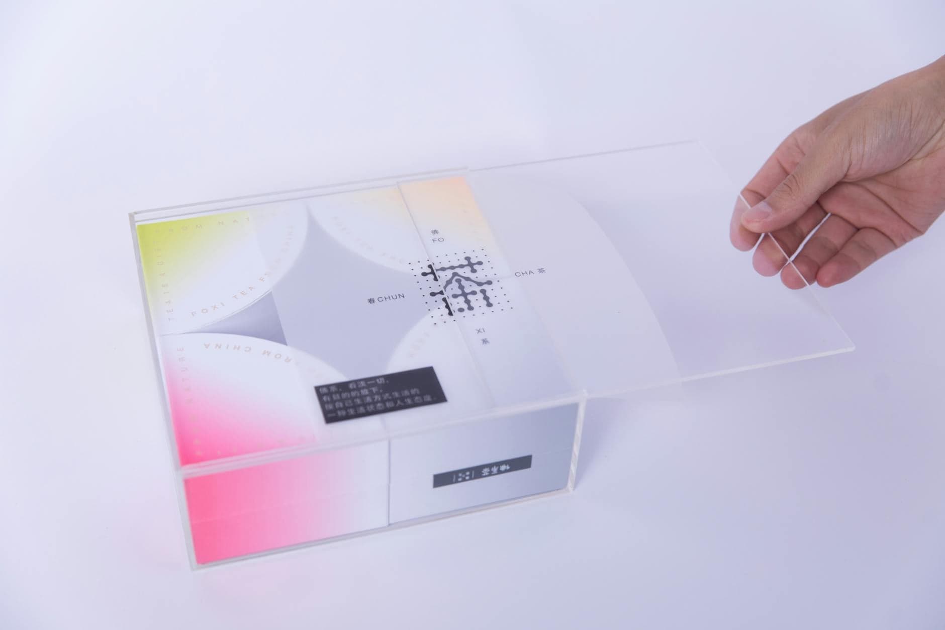 Modern packaging design with transparent lid showing clean typography and brand identity